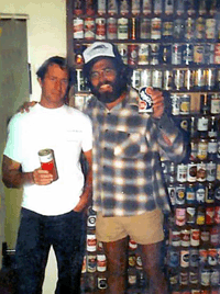 Jon Sarrett and Jack standing in front of Jacks beer collection - photo by Dave Osborn