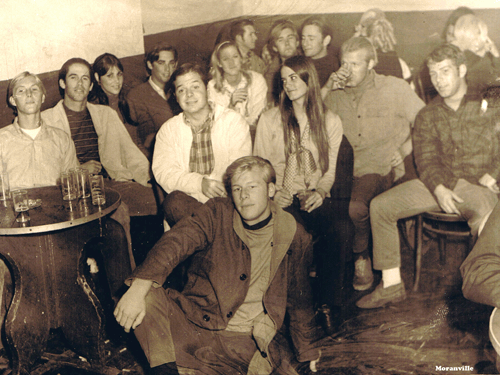 Very old Meda Photo of the meda crowd at the Long Bar and I took it. Billy Humes in the front center. Front left: John Brower, Moon Taylor, Kathy ?,  Tommy Doyle, (Blond) Kathy Haddock, Tom Damm and Maynard (dark hair girl), Richard Ernest, and Bob Balanca in the center. I may be Wayne Cummings in the back corner and Joe Hallow next to a guy we have seen in alot of the pics but can't place who he is. This is way back in the 60s. Photo by Doug Moranville 